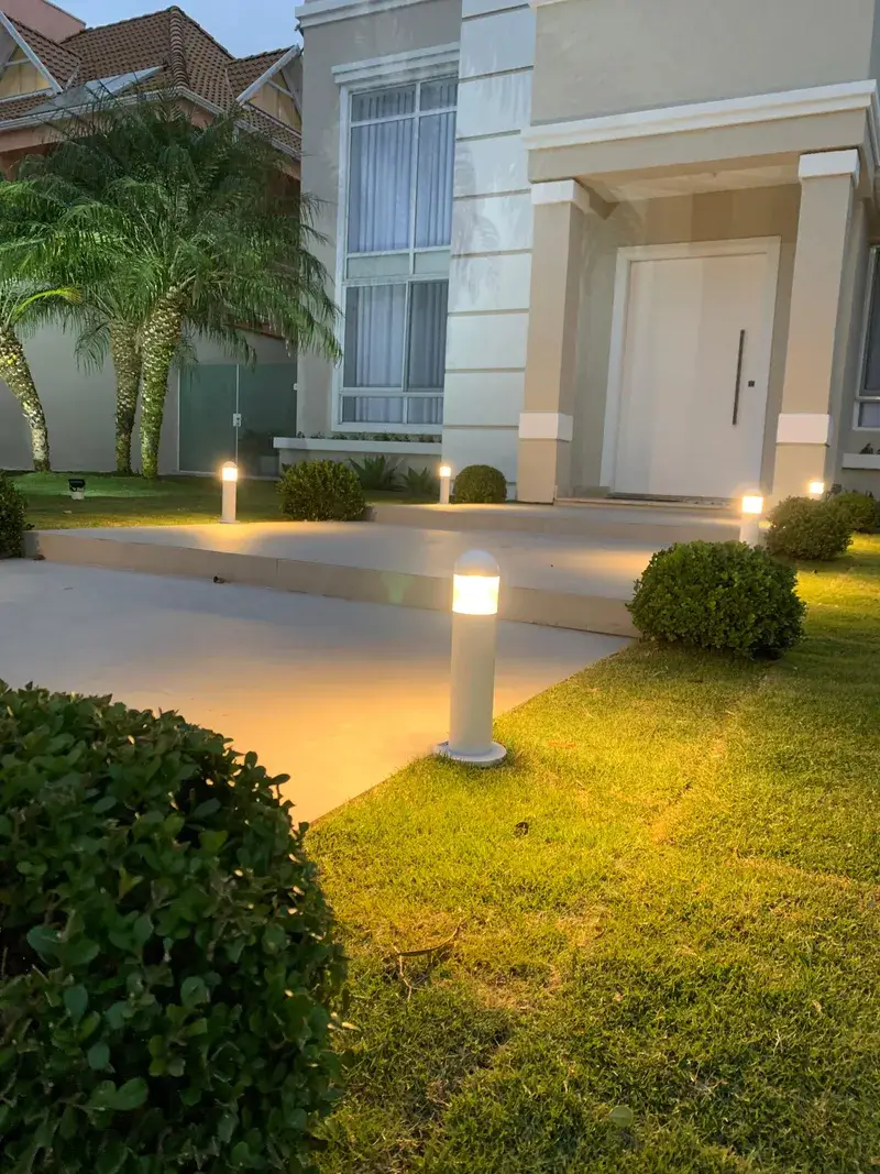 Close de balizadores de jardim instalados em zona de relvado e caminho